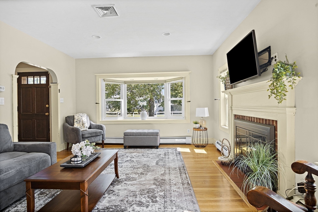 56 Summer Street Saugus, MA 01906 - Photo 2 of 29 a living room with furniture a fireplace and a flat screen tv