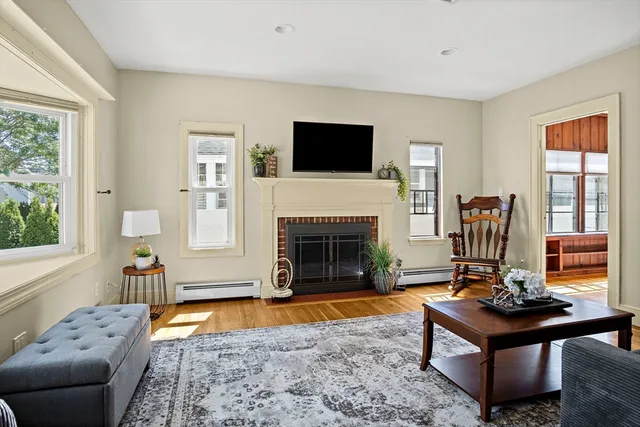 a living room with furniture a flat screen tv and a fireplace