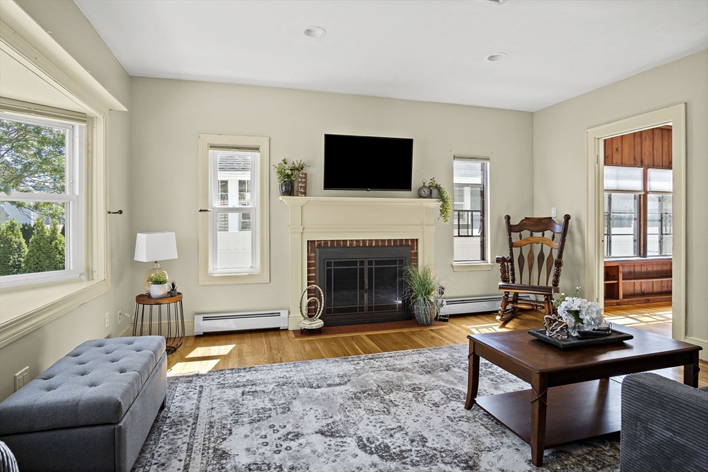 56 Summer Street Saugus, MA 01906 - Photo 3 of 29 a living room with furniture a flat screen tv and a fireplace