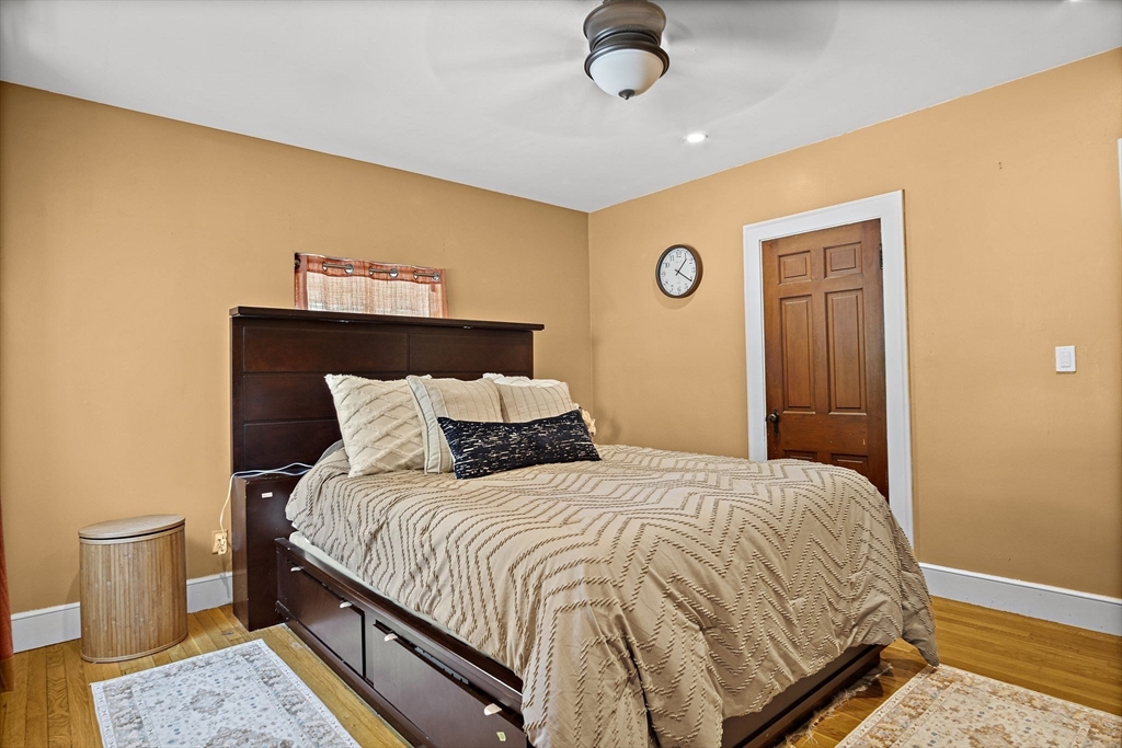 56 Summer Street Saugus, MA 01906 - Photo 10 of 29 a bedroom with a bed and dresser with wooden floor