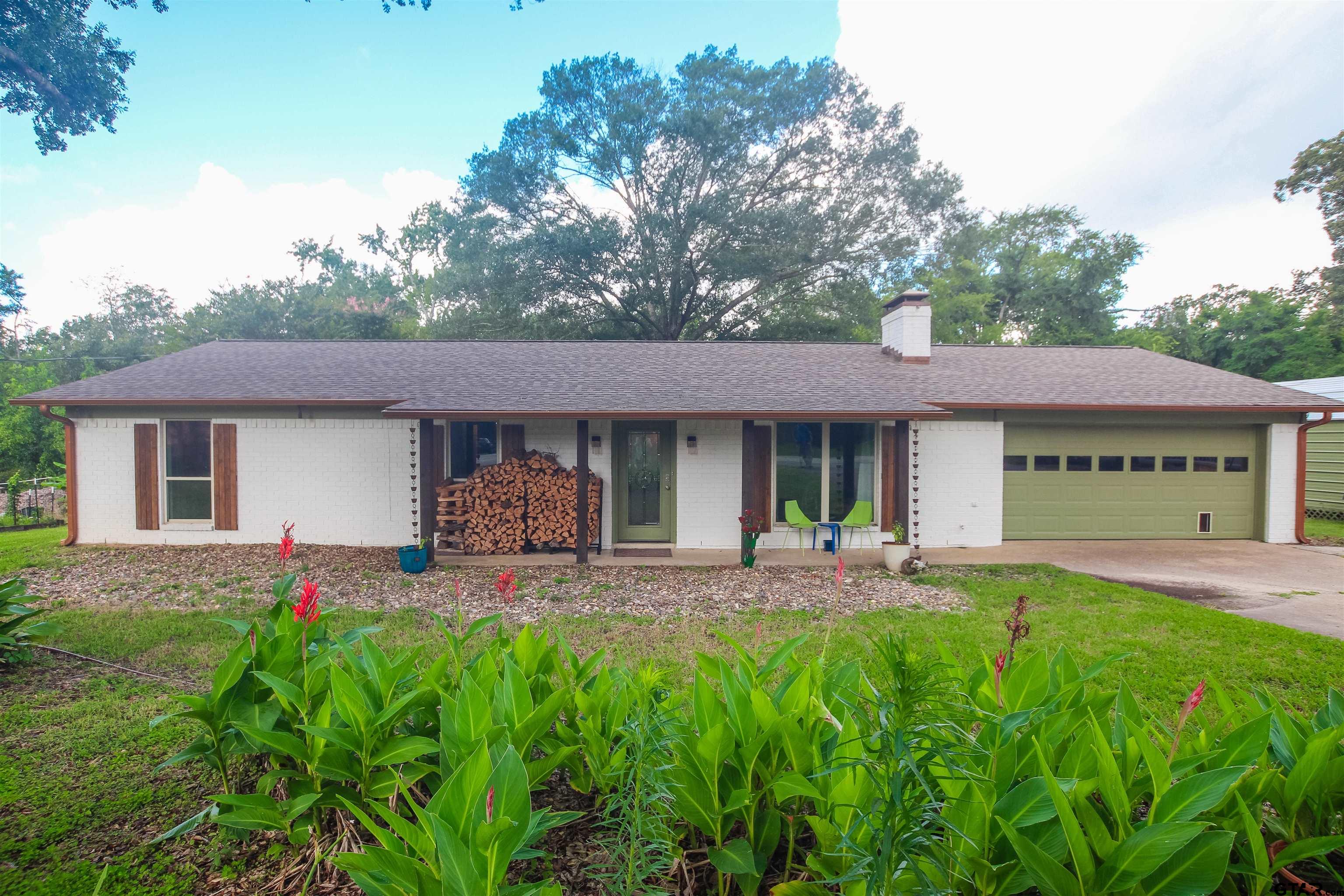 7546 Hill N Dale Road Tyler, TX 75709 - Photo 1 of 24 a front view of a house with a garden and patio