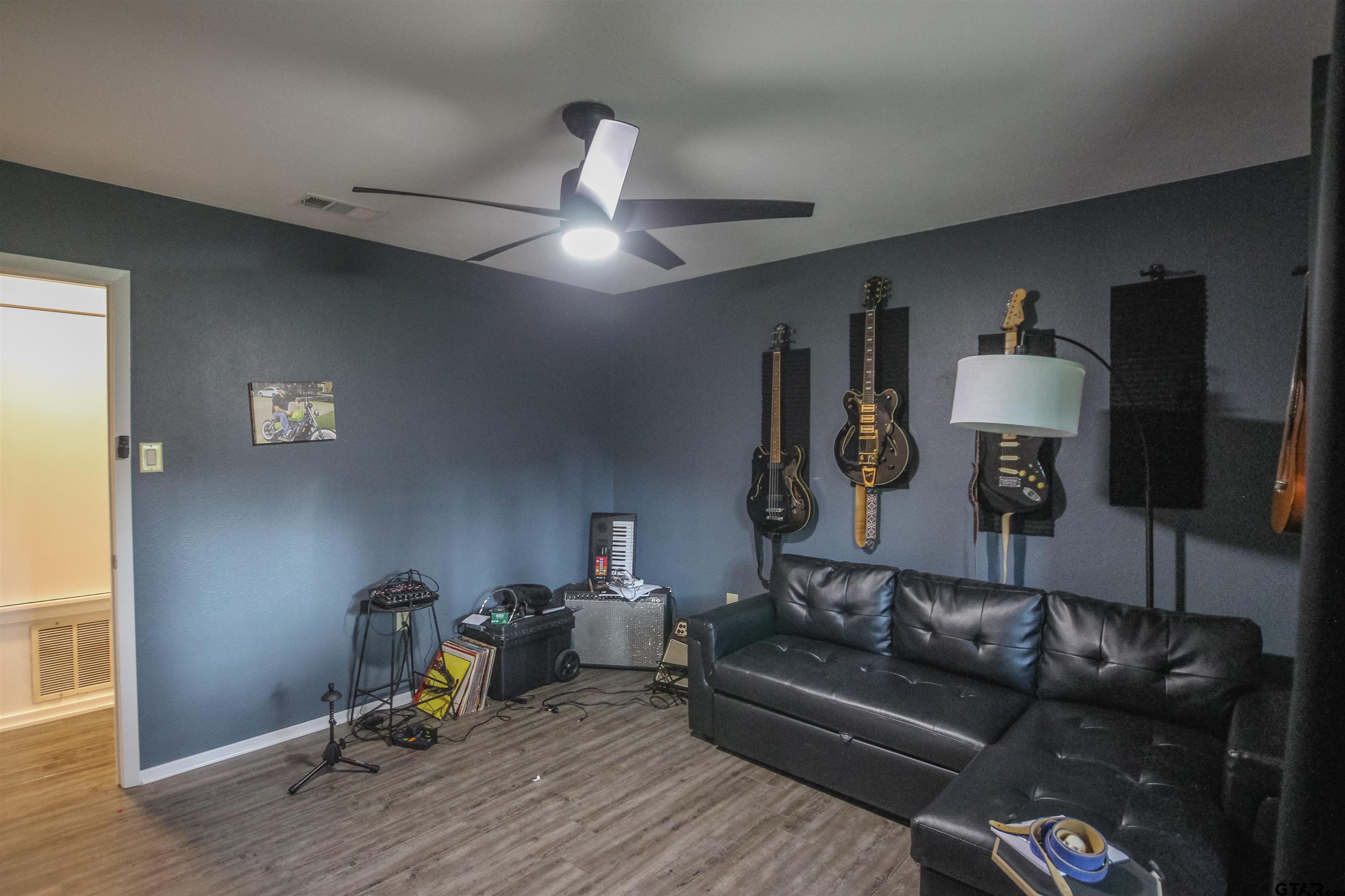 7546 Hill N Dale Road Tyler, TX 75709 - Photo 16 of 24 a living room with furniture and a wooden floor
