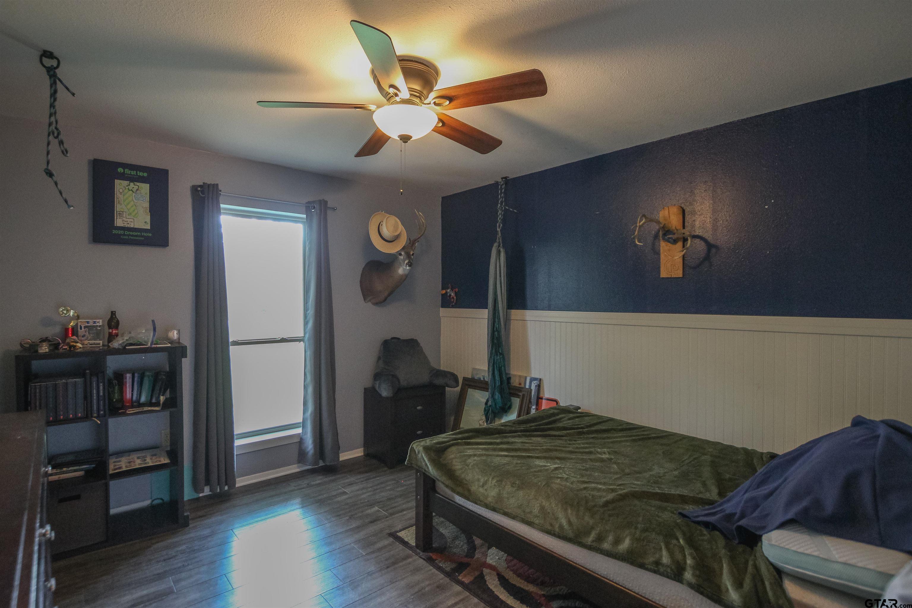 7546 Hill N Dale Road Tyler, TX 75709 - Photo 18 of 24 a living room with a bed