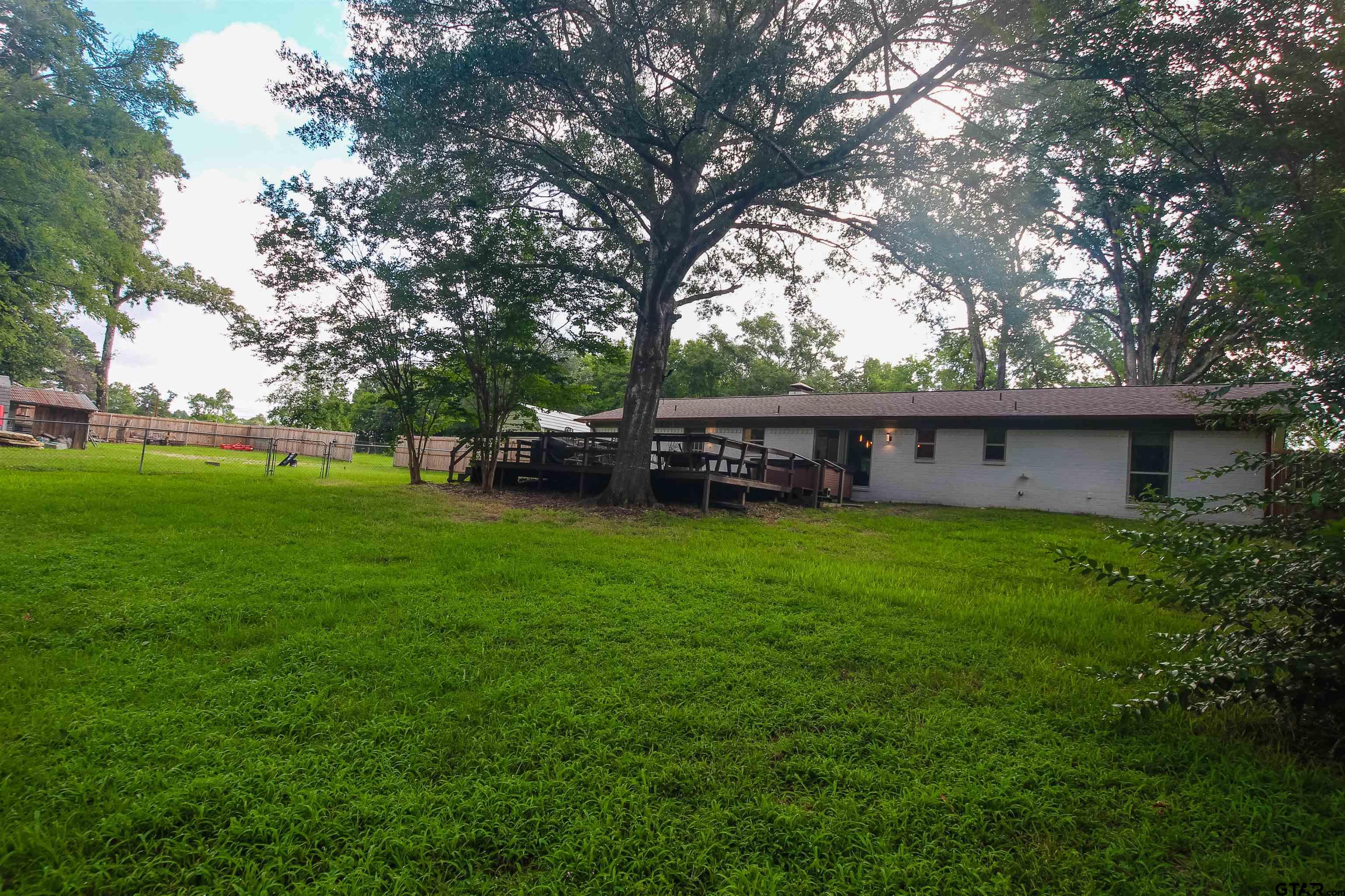 7546 Hill N Dale Road Tyler, TX 75709 - Photo 19 of 24 a view of a house with a yard