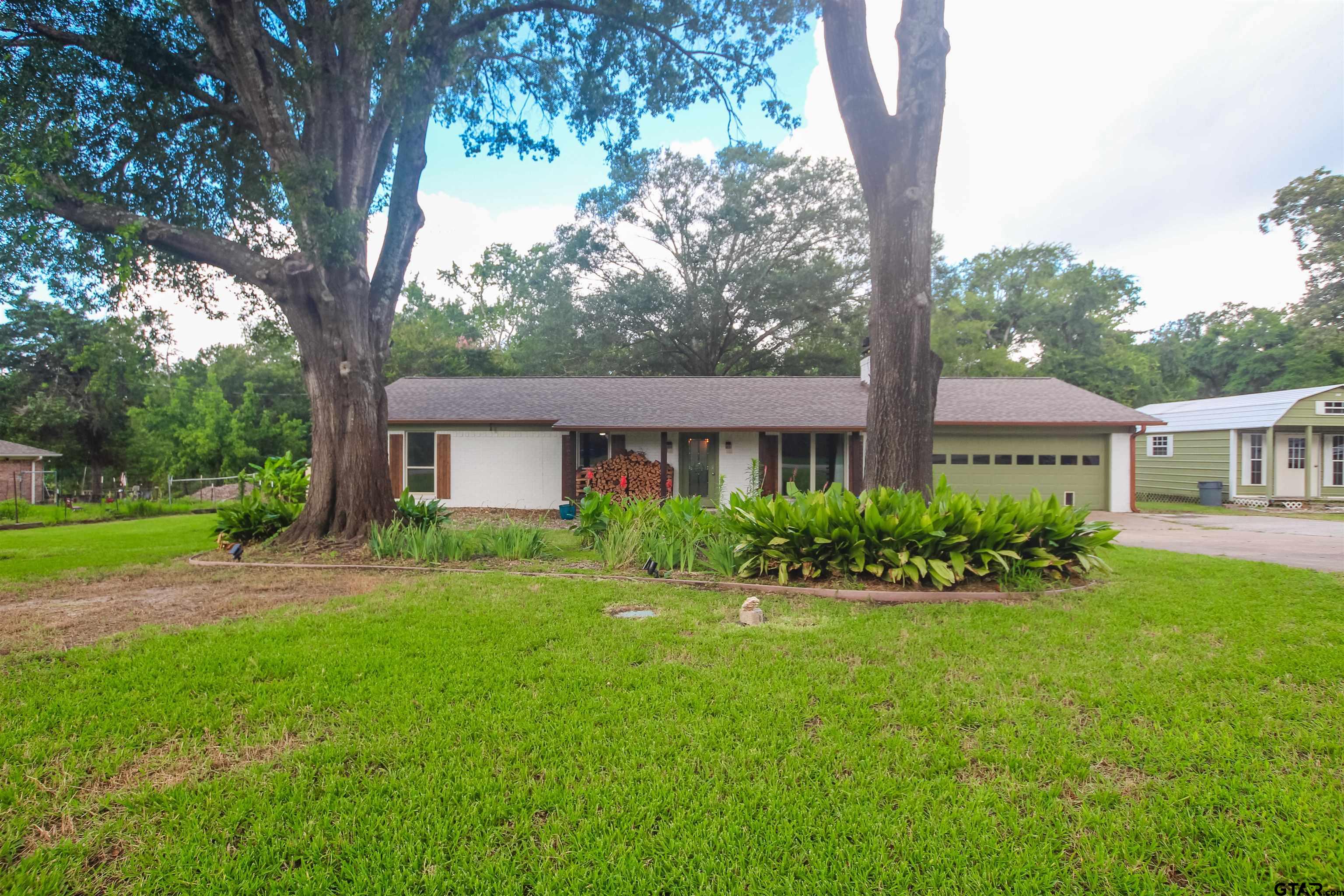 7546 Hill N Dale Road Tyler, TX 75709 - Photo 2 of 24 a front view of a house with a yard and porch