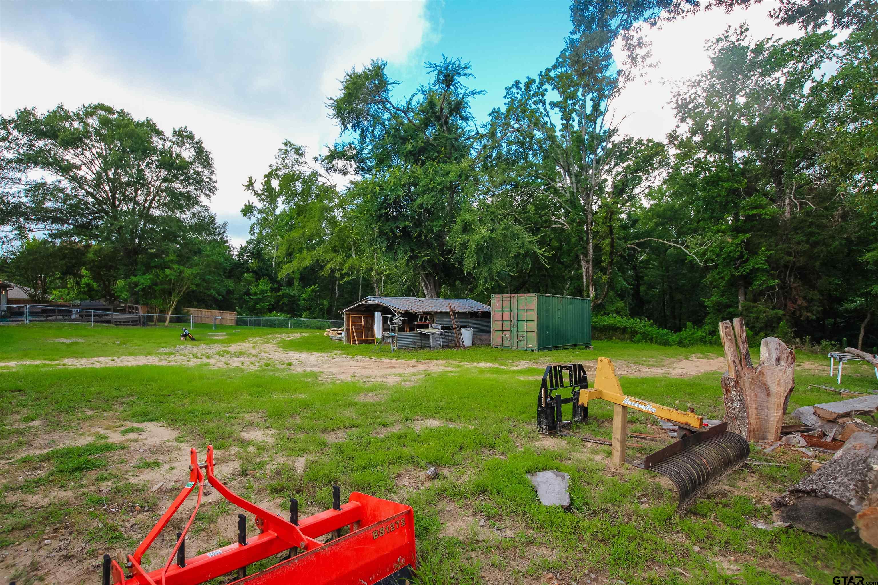 7546 Hill N Dale Road Tyler, TX 75709 - Photo 21 of 24 a backyard of a house with a yard and outdoor seating
