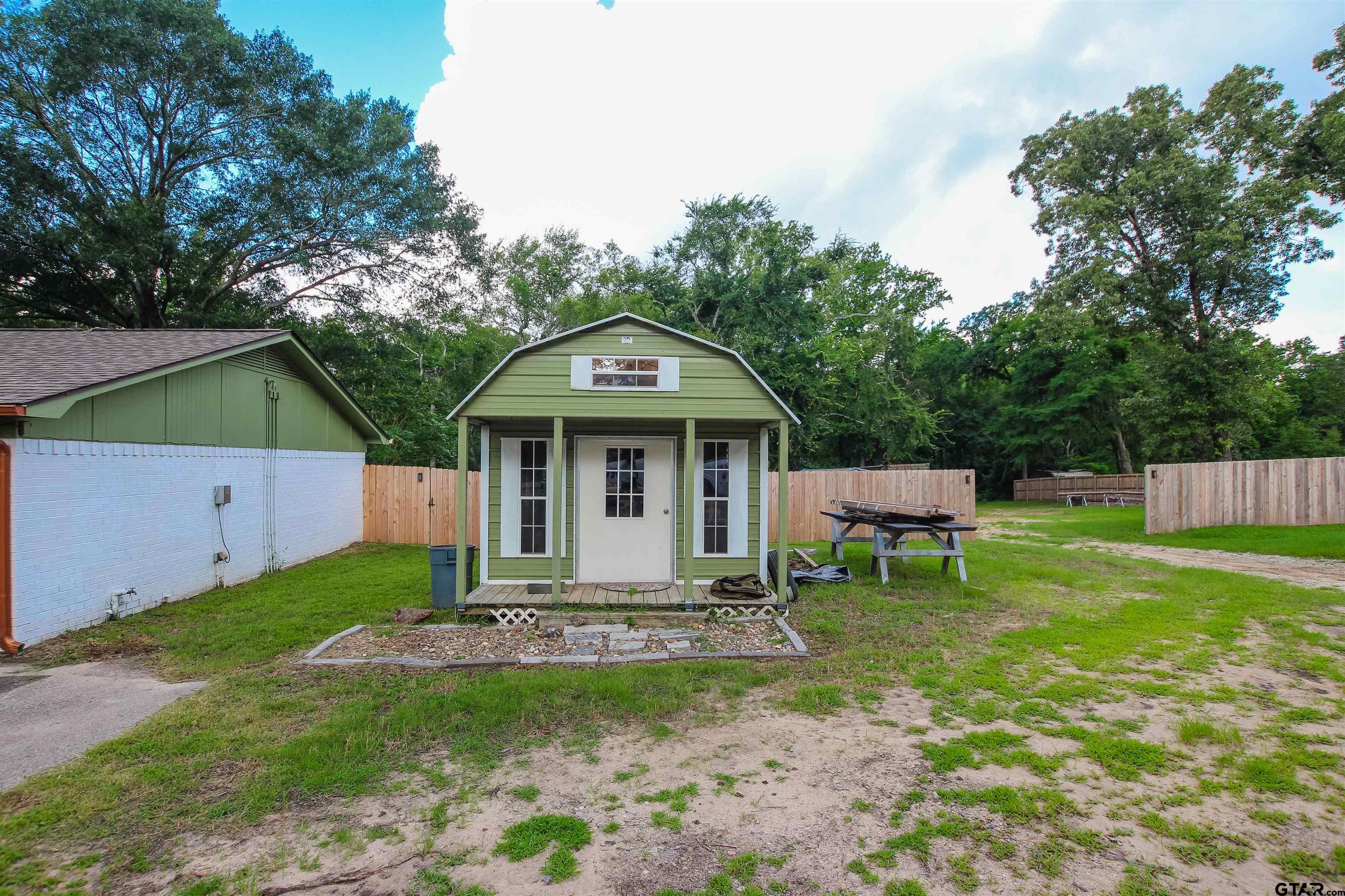 7546 Hill N Dale Road Tyler, TX 75709 - Photo 23 of 24 a front view of a house with garden