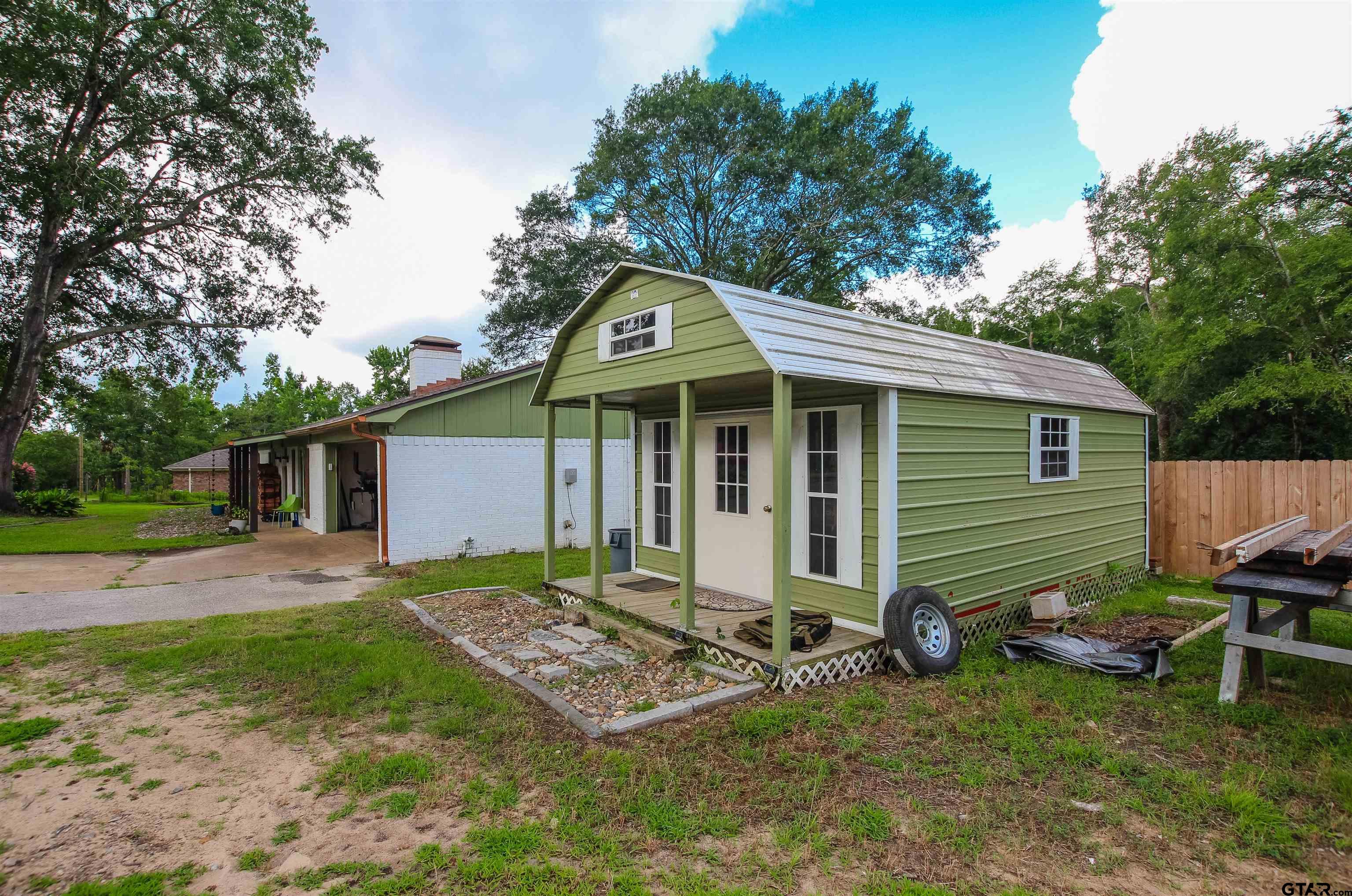 7546 Hill N Dale Road Tyler, TX 75709 - Photo 24 of 24 a backyard of a house with table and chairs