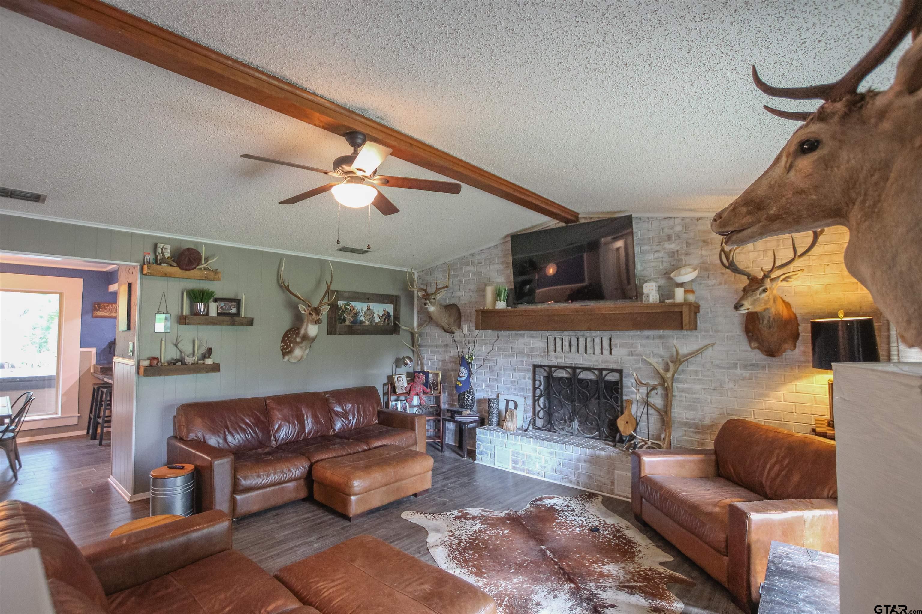 7546 Hill N Dale Road Tyler, TX 75709 - Photo 3 of 24 a living room with furniture and a fireplace