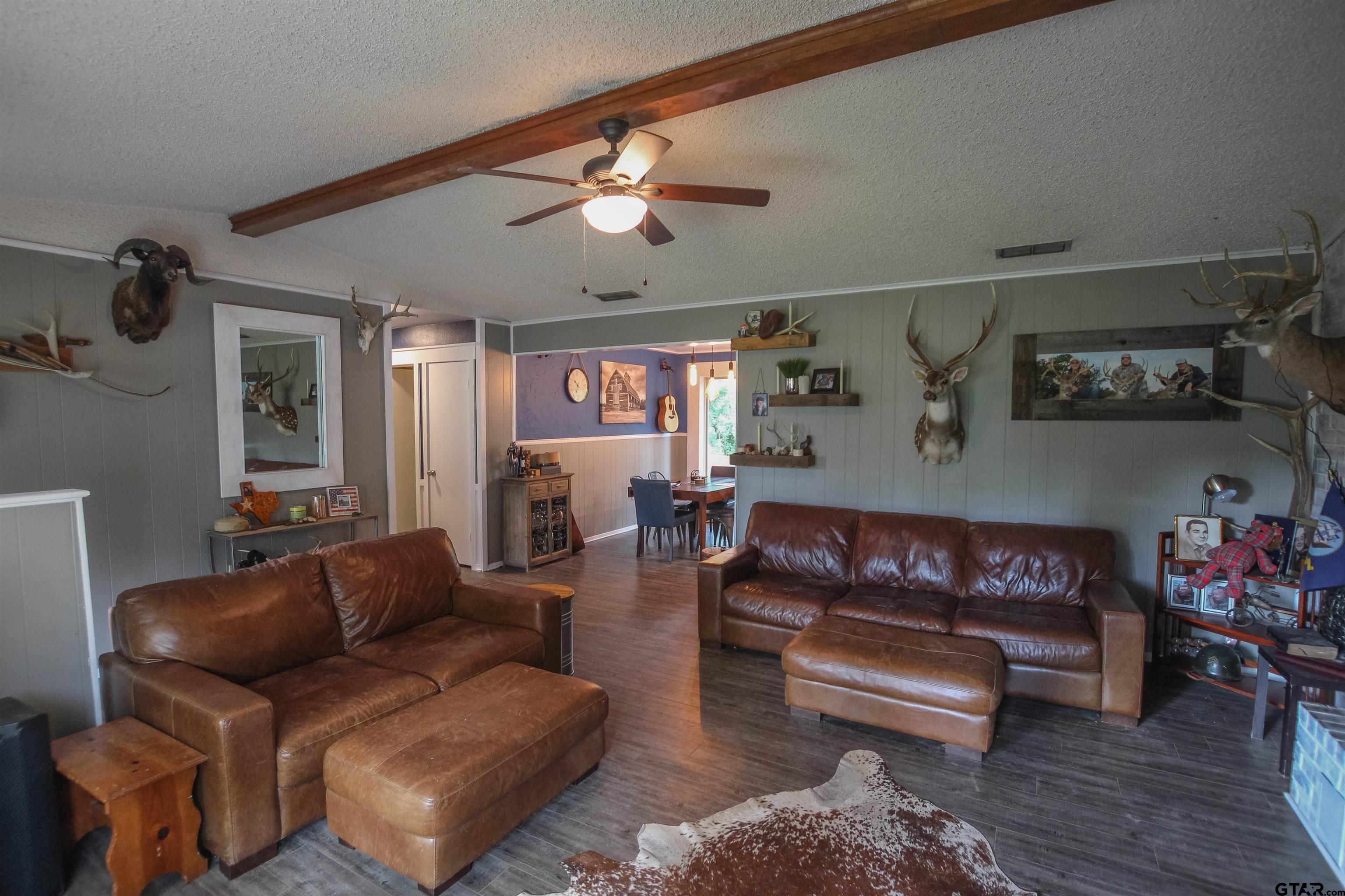 7546 Hill N Dale Road Tyler, TX 75709 - Photo 4 of 24 a living room with furniture a rug and white walls