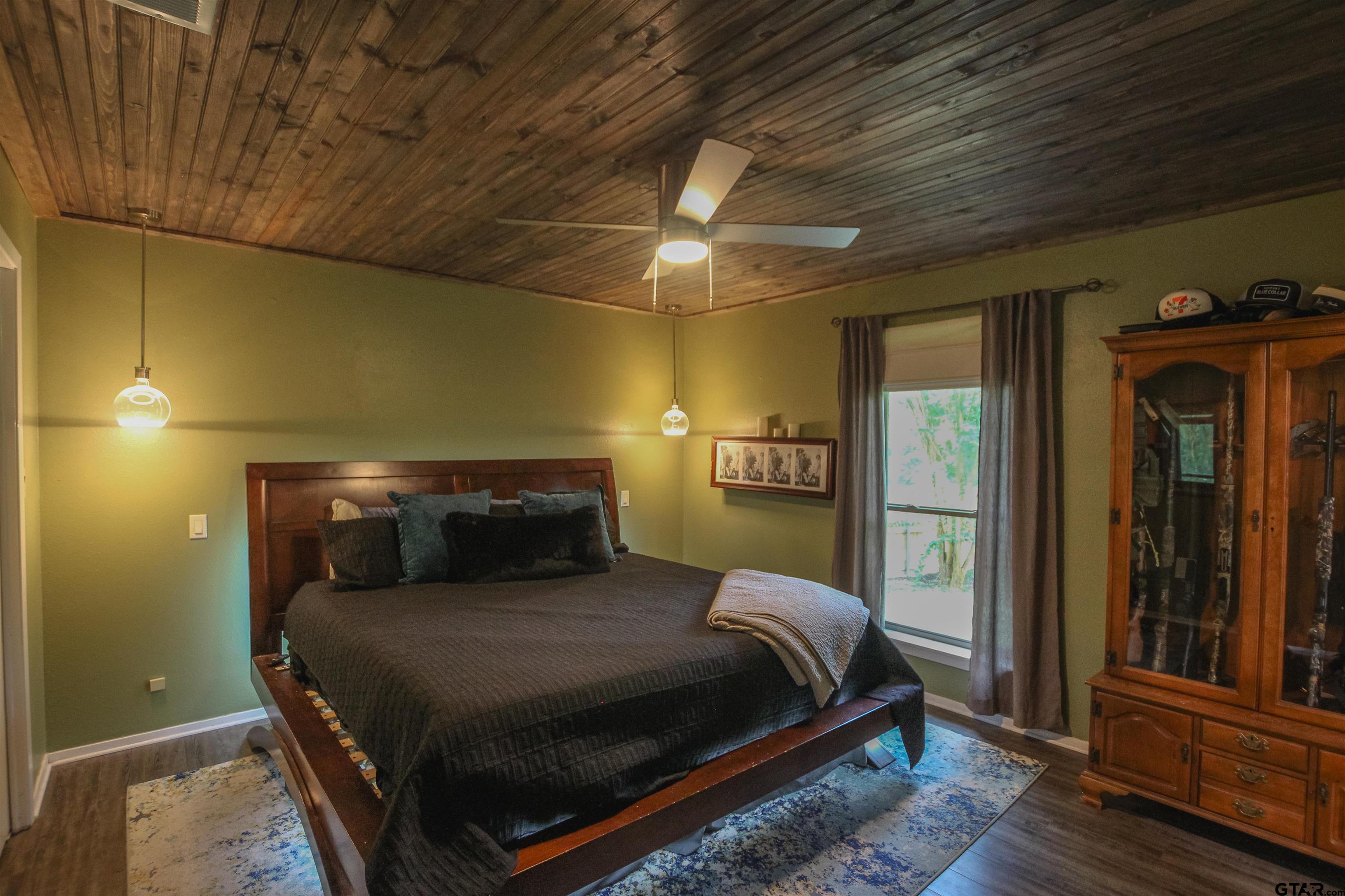 7546 Hill N Dale Road Tyler, TX 75709 - Photo 10 of 24 a bedroom with a bed and wooden floor