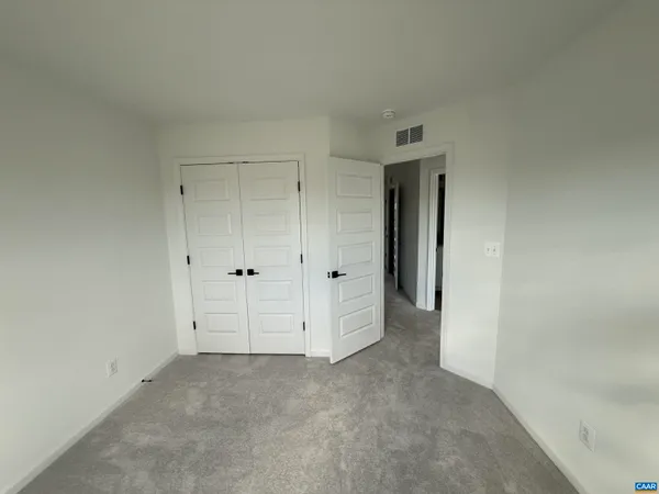 an empty room with closet area