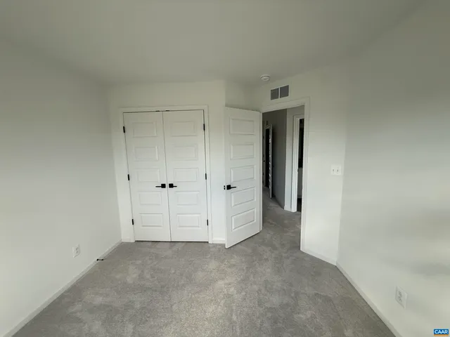 an empty room with closet area