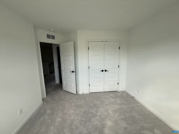 an empty room with closet area
