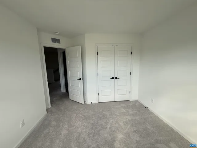 an empty room with closet area
