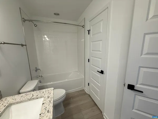 a bathroom with a tub and a shower
