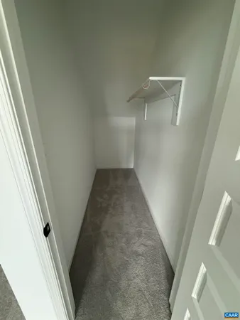 a view of an empty room and wooden floor