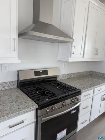 a stove top oven sitting inside of a kitchen