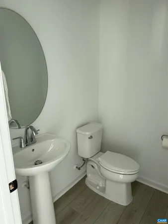 a white toilet sitting next to a bathroom sink