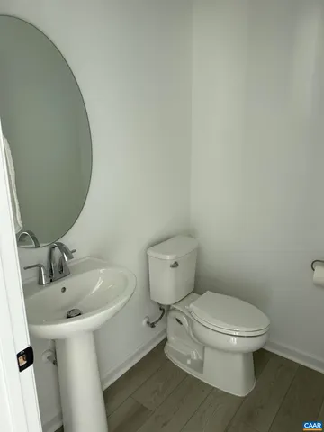a white toilet sitting next to a bathroom sink