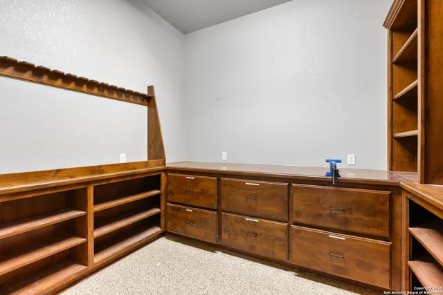 a spacious bathroom with a tub and a flat screen tv