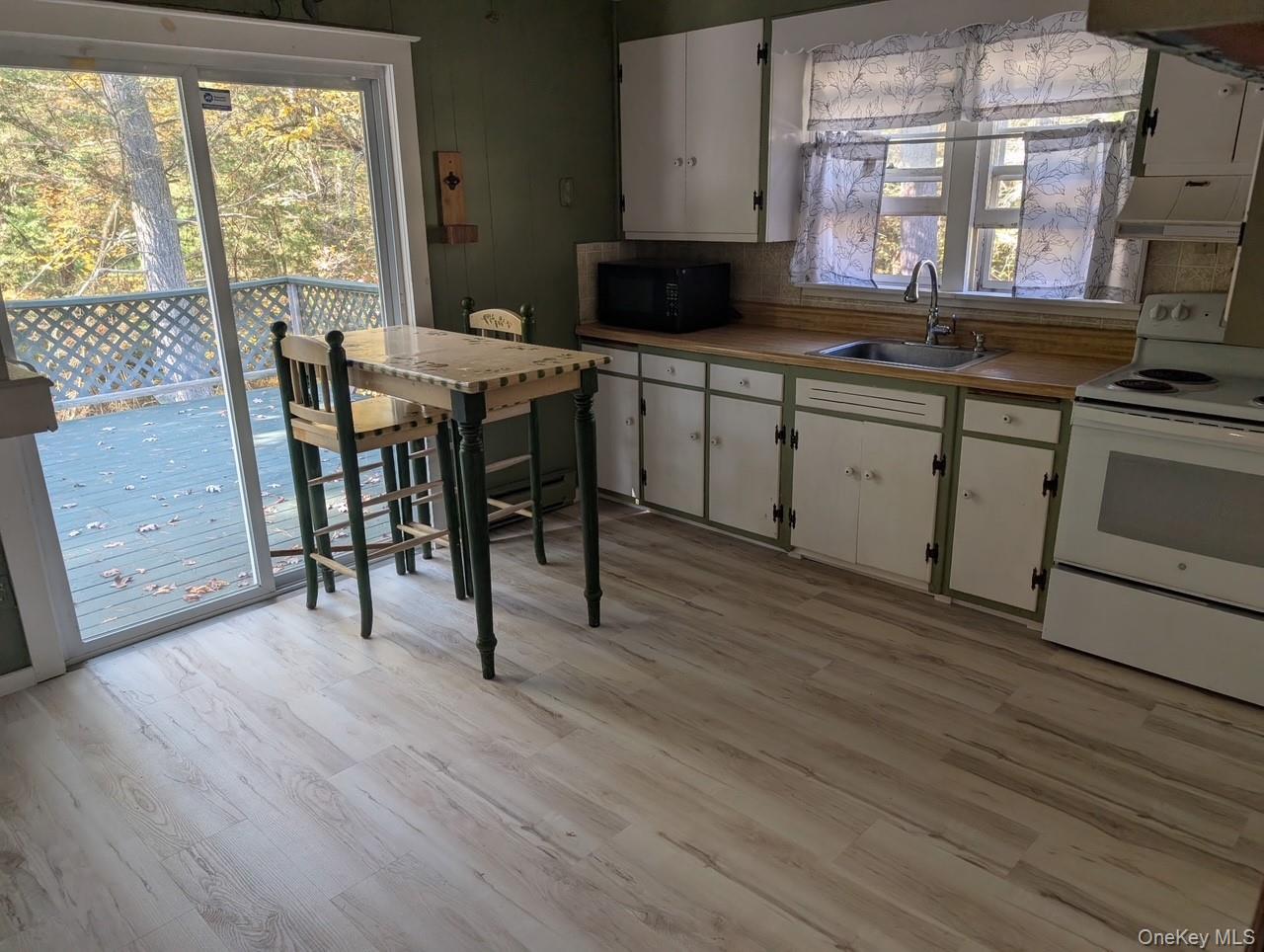 50 Park Road Yulan, NY 12792 - Photo 5 of 14 a kitchen with a sink a stove cabinets and wooden floor