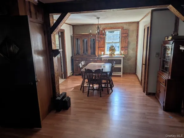 an open kitchen with dining table and stainless steel appliances