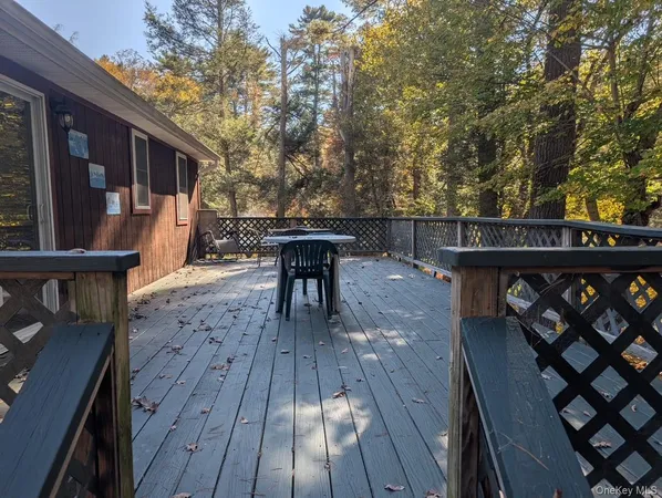 a view of a deck with wooden floor and outdoor seating