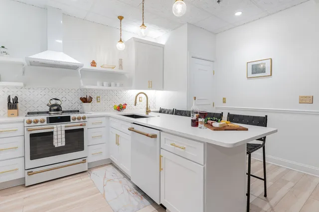 a kitchen with a sink a stove and cabinets