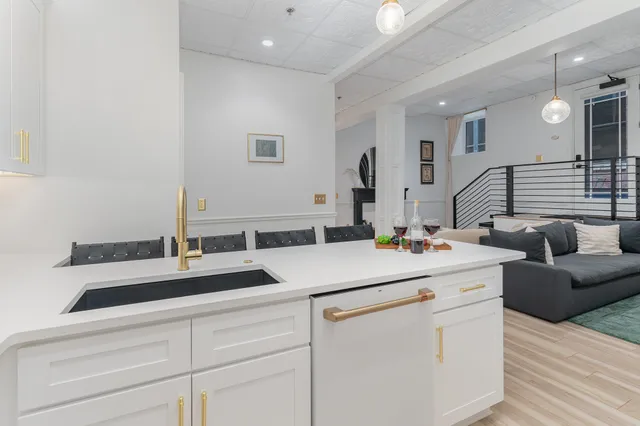 a kitchen with a sink and a mirror