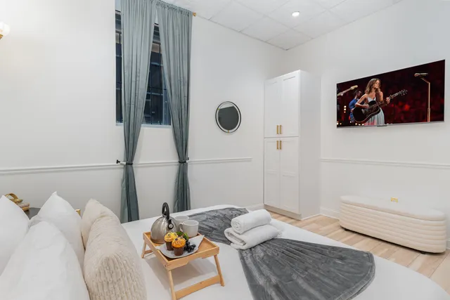 a bedroom with a bed and a window