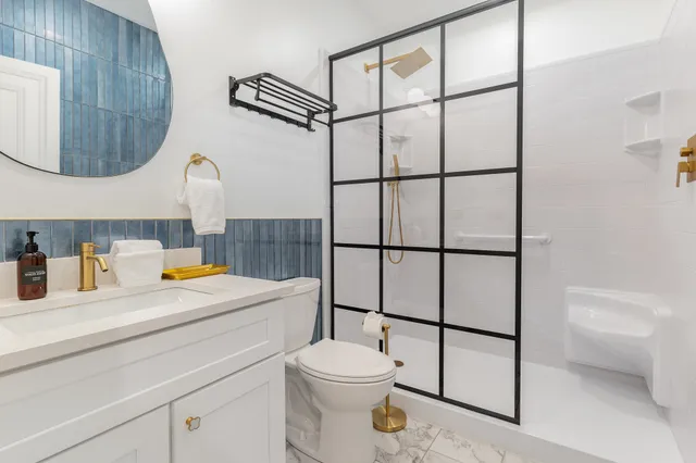 a bathroom with a sink toilet and shower