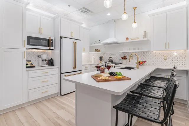 a kitchen with a sink stove and refrigerator