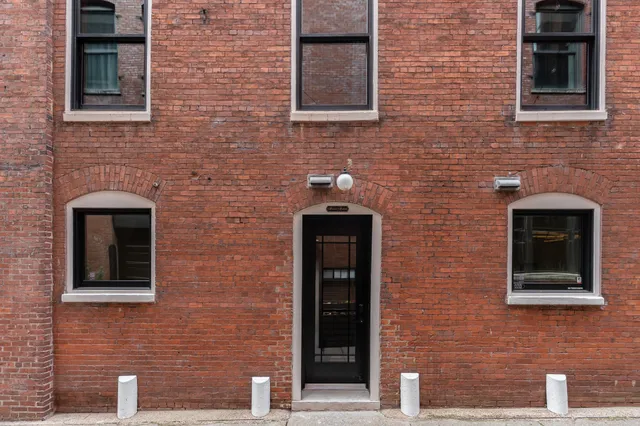 a brick house with a door and a door
