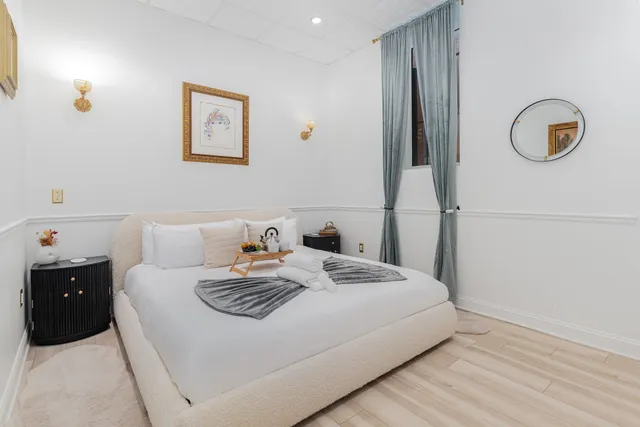 a bedroom with a bed and a lamp