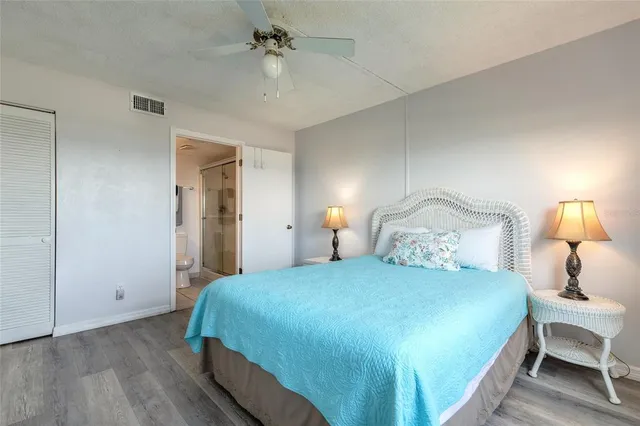 a bedroom with a bed and a lamp