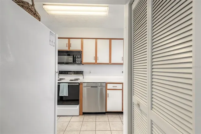a kitchen with stainless steel appliances a sink window and cabinets