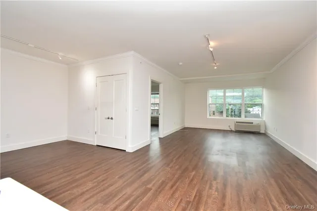 a view of hallway with wooden floor