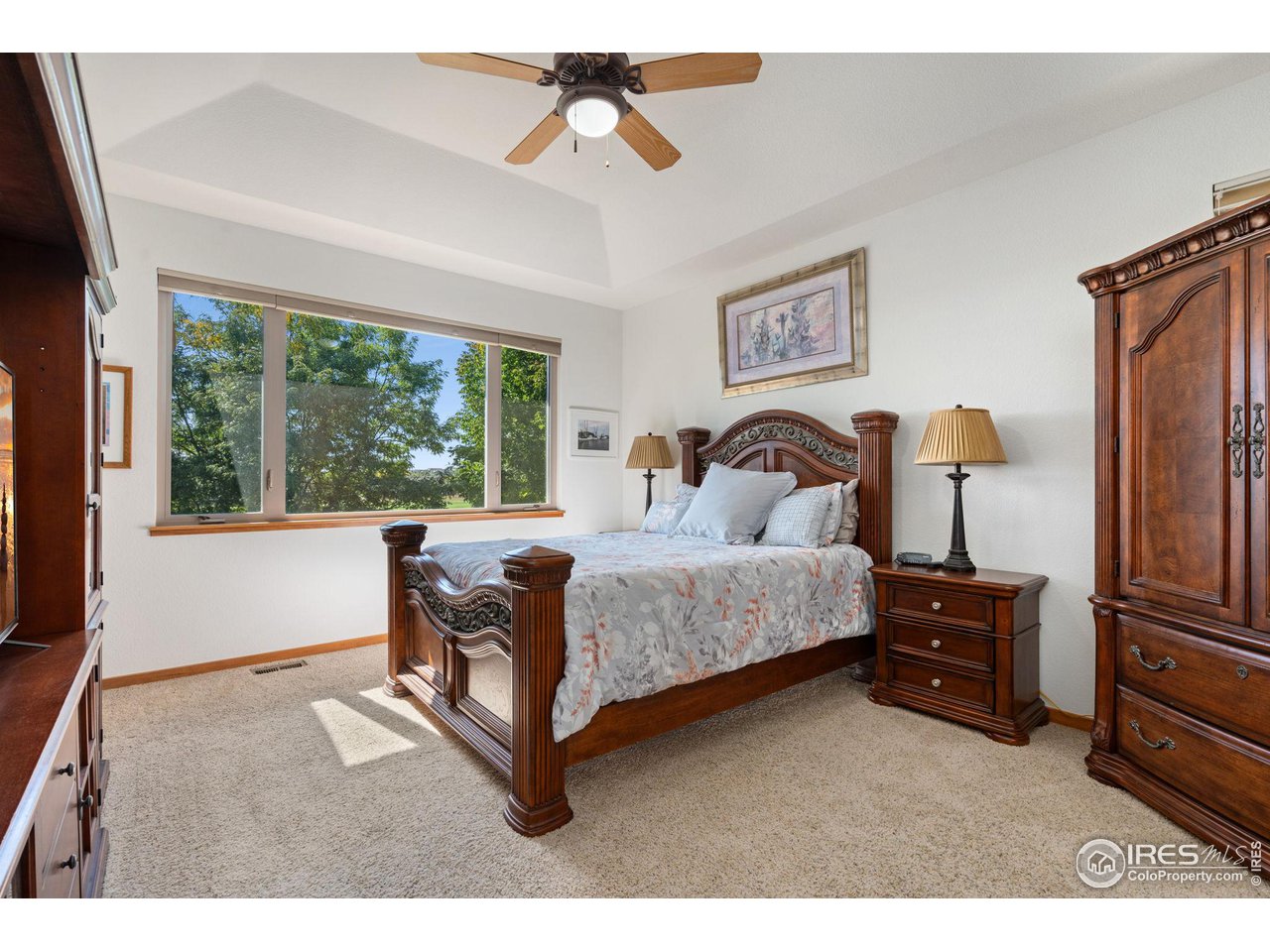 6747 Spanish Bay Drive Windsor, CO 80550 - Photo 15 of 30 a bedroom with a bed wooden floor and window