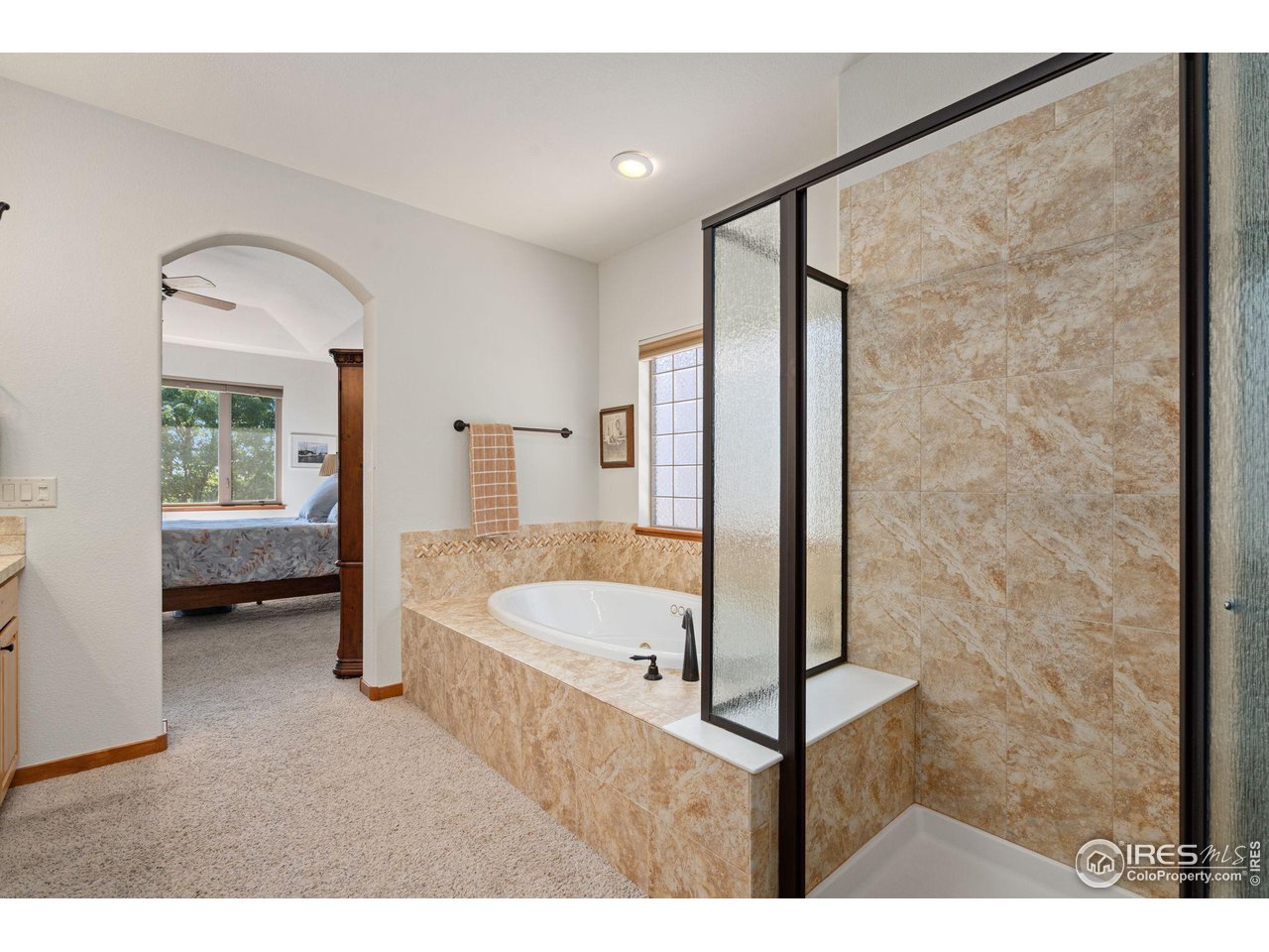 6747 Spanish Bay Drive Windsor, CO 80550 - Photo 18 of 30 a en suite bathroom with a tub shower and sink