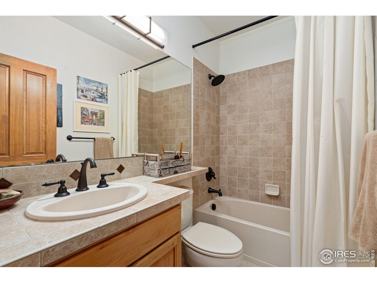 6747 Spanish Bay Drive Windsor, CO 80550 - Photo 20 of 30 a bathroom with a sink toilet a mirror a bathtub and shower