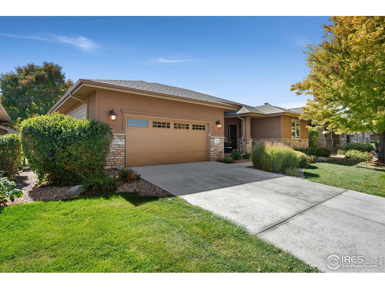 6747 Spanish Bay Drive Windsor, CO 80550 - Photo 26 of 30 a front view of a house with a yard and garage