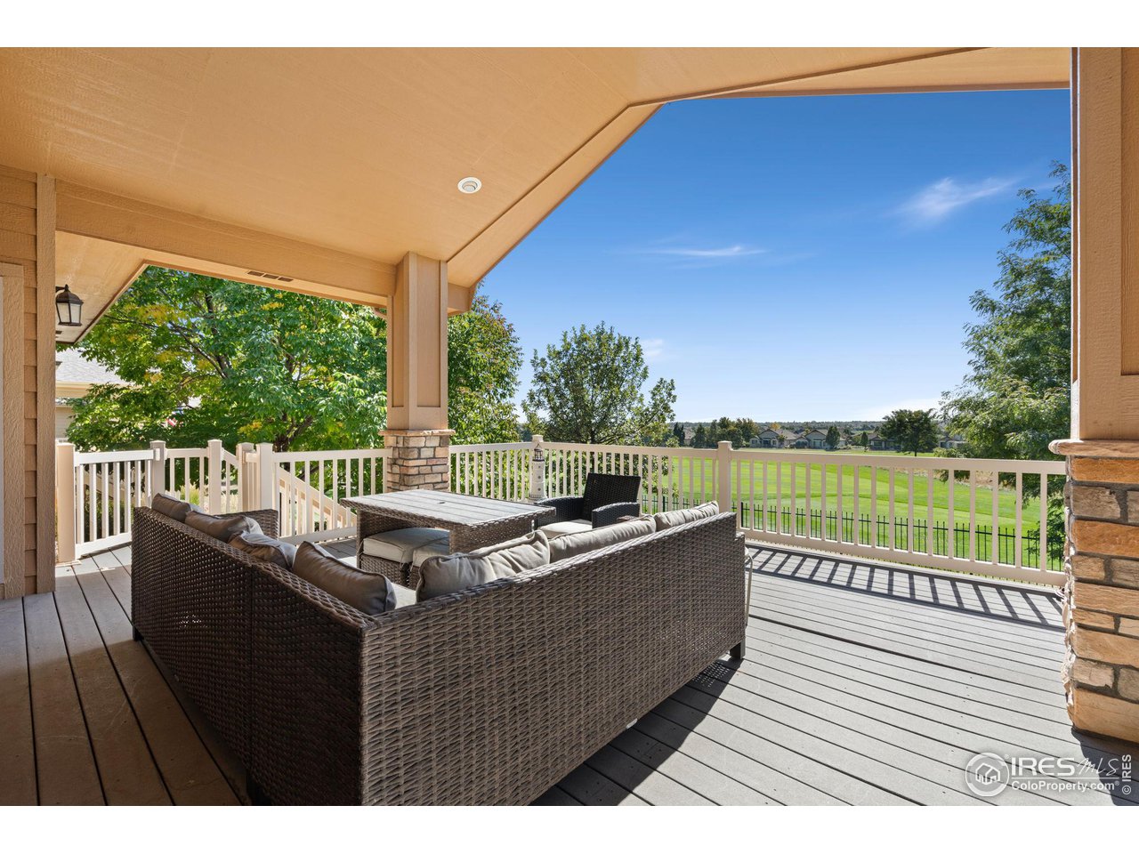 6747 Spanish Bay Drive Windsor, CO 80550 - Photo 3 of 30 a view of a balcony with wooden floor and lake view