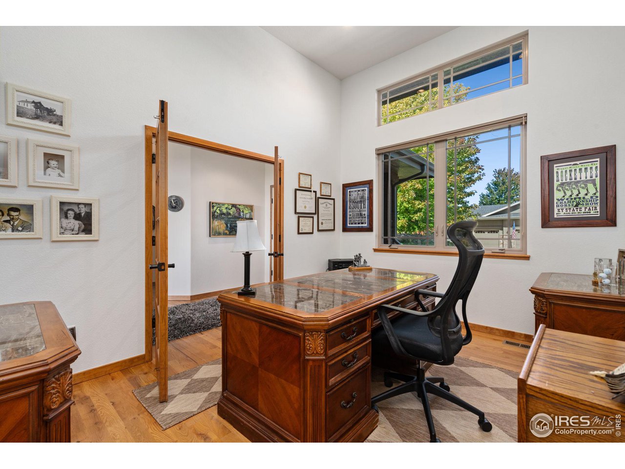 6747 Spanish Bay Drive Windsor, CO 80550 - Photo 6 of 30 a dining room with furniture a large window and a chandelier