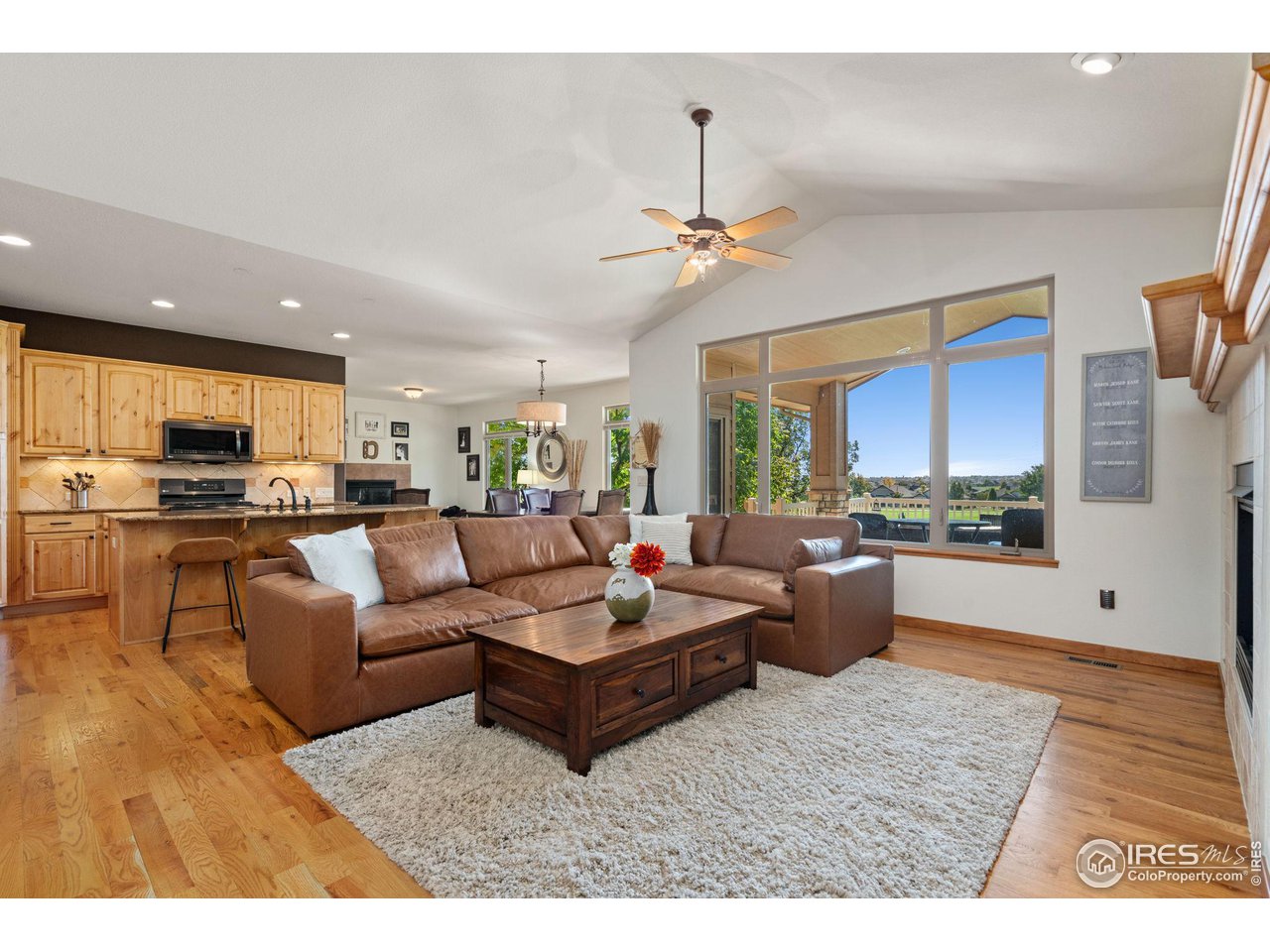 6747 Spanish Bay Drive Windsor, CO 80550 - Photo 30 of 30 a living room with furniture kitchen view and a large window