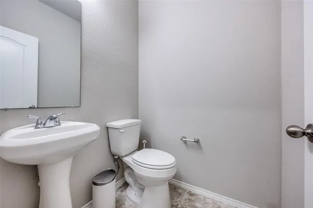 a bathroom with a sink mirror and toilet