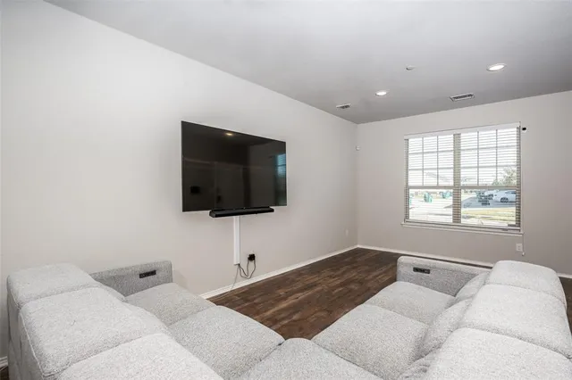 a living room with a flat screen tv and a window