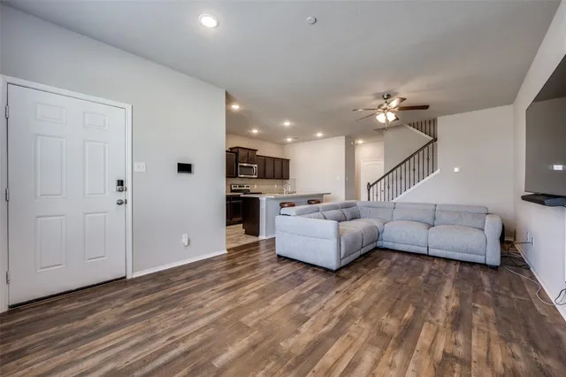 a living room with furniture and wooden floor