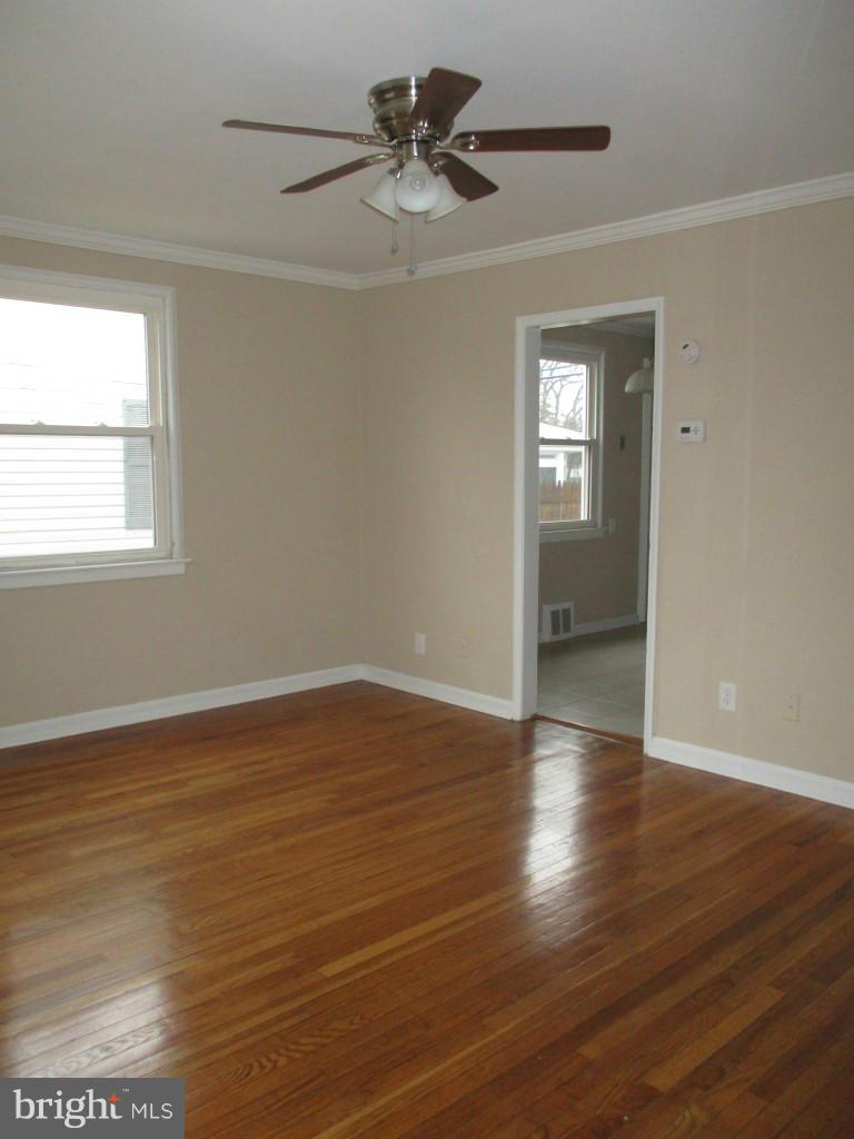 8200 Northview Road Baltimore, MD 21222 - Photo 2 of 14 wooden floor in an empty room with a window