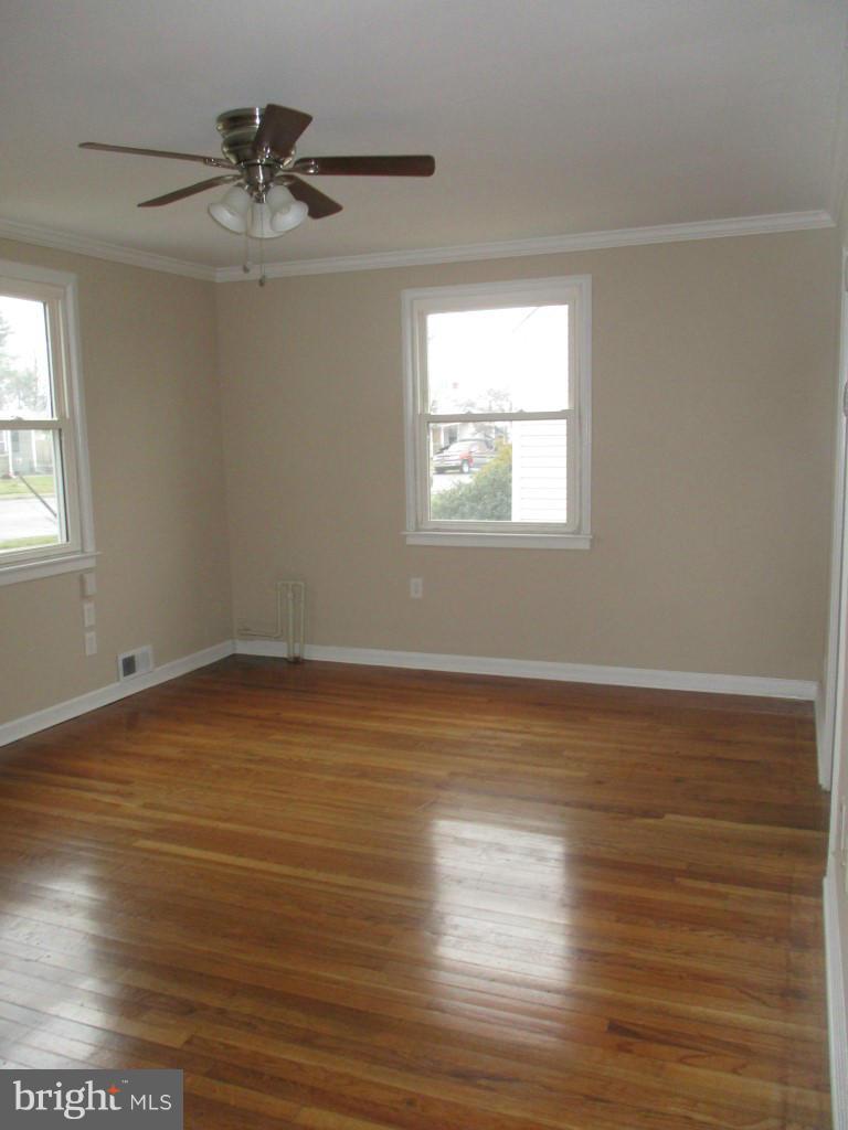 8200 Northview Road Baltimore, MD 21222 - Photo 3 of 14 an empty room with wooden floor and windows